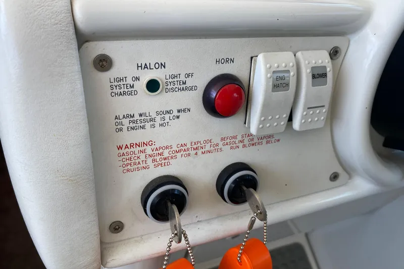 Slide: The Image of Control panel of a 2002 Formula 382 FASTech boat with warning labels and switches. - 25
