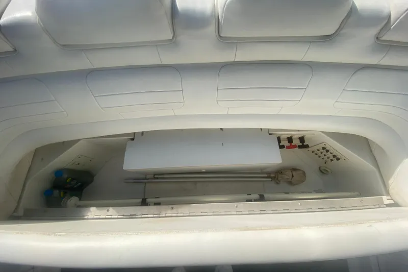 Slide: The Image of Interior storage compartment of a 2002 Formula 382 FASTech boat, featuring white upholstery. - 32