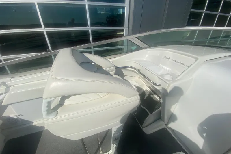 Slide: The Image of 2002 Formula 382 FASTech boat cockpit with white seating and dashboard details. - 35