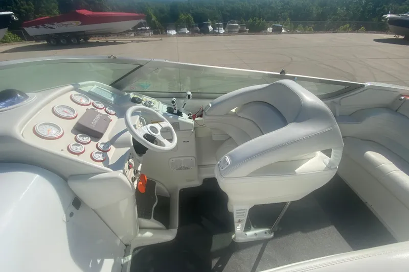 Slide: The Image of 2002 Formula 382 FASTech boat cockpit with white seating and dashboard controls. - 37