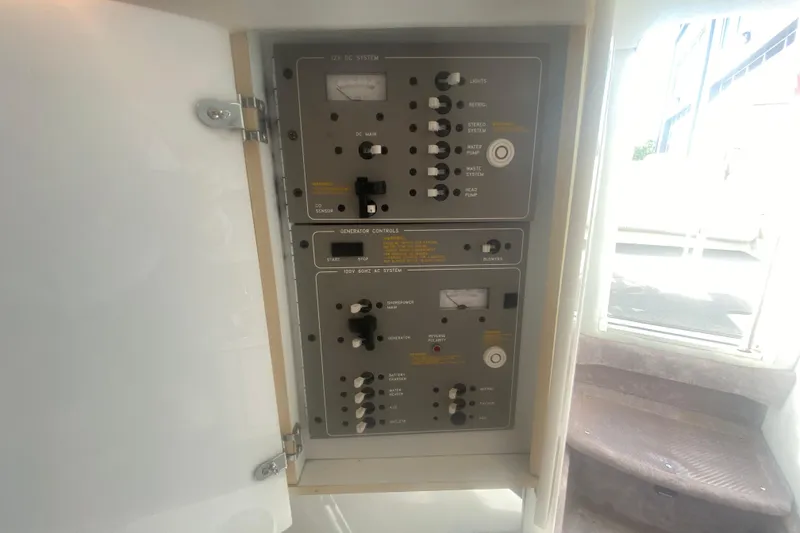 Slide: The Image of Control panel inside 2002 Formula 382 FASTech boat, featuring various switches and gauges. - 40