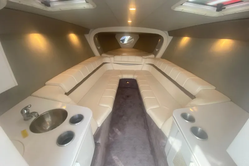 Slide: The Image of Interior of 2002 Formula 382 FASTech boat with plush seating and compact kitchenette. - 42