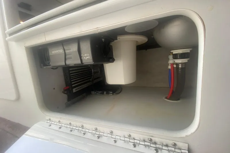 Slide: The Image of 2002 Formula 382 FASTech boat compartment with Kenwood audio system and plumbing components. - 45