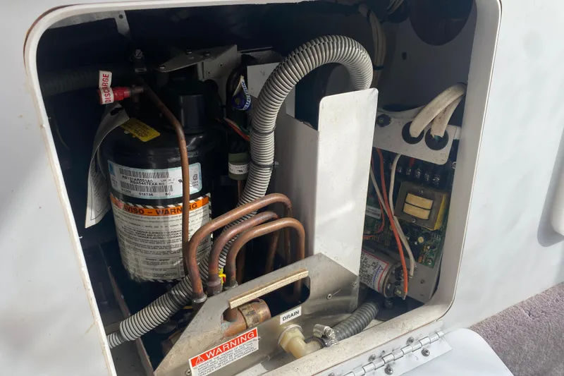 Slide: The Image of Engine compartment of a 2002 Formula 382 FASTech boat, showcasing mechanical components and wiring. - 46