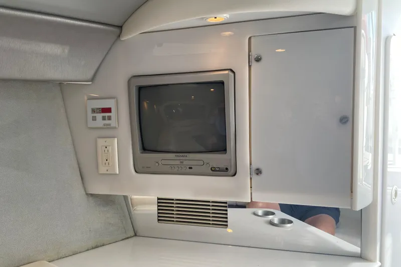 Slide: The Image of 2002 Formula 382 FASTech cabin interior with TV, control panel, and storage cabinet. - 47