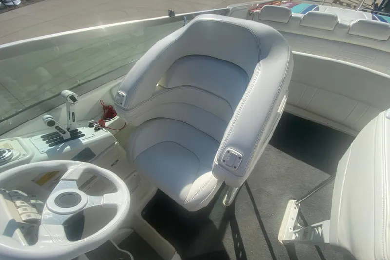 Slide: The Image of 2002 Formula 382 FASTech boat cockpit with white leather seating and steering wheel. - 49
