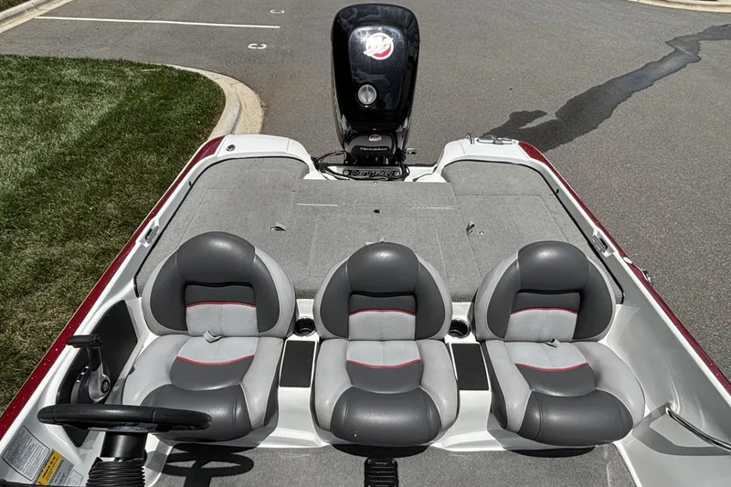 Slide: The Image of 2014 Nitro Z-6 boat interior with three gray seats and steering wheel. - 13