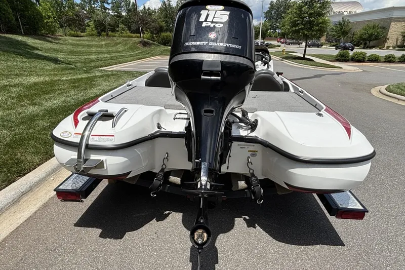 Slide: The Image of 2014 Nitro Z-6 boat with 115 Pro motor on a trailer, parked on a sunny street. - 19