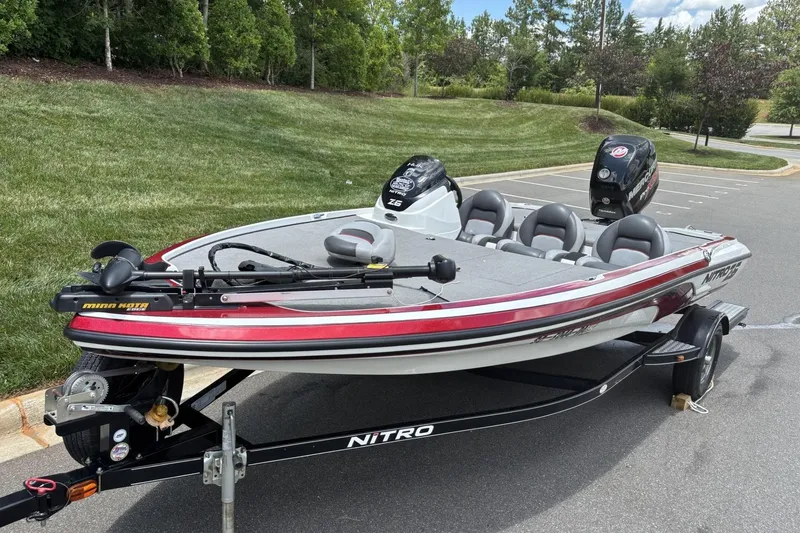 Slide: The Image of 2014 Nitro Z-6 boat with Minn Kota trolling motor on trailer, parked outdoors. - 3