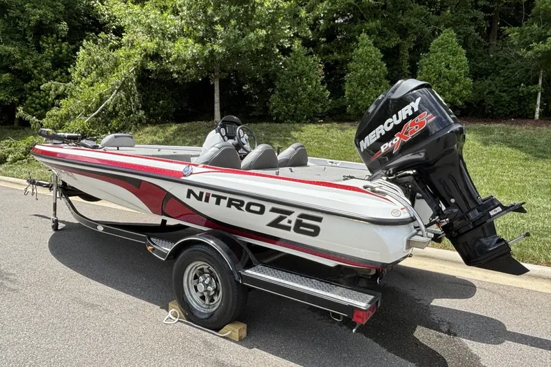 Slide: The Image of 2014 Nitro Z-6 boat with Mercury Pro XS engine on a trailer, parked outdoors. - 6