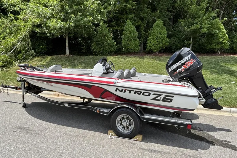 Slide: The Image of 2014 Nitro Z-6 boat with Mercury Pro XS engine on a trailer, parked outdoors. - 7