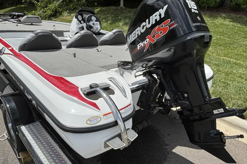 Slide: The Image of 2014 Nitro Z-6 boat with Mercury Pro XS 115 engine, parked on a trailer. - 8