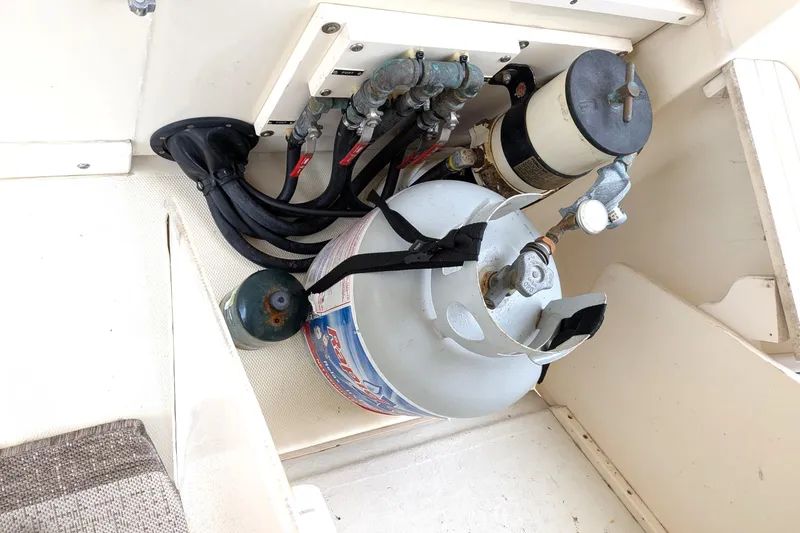 Slide: The Image of Propane tank and fuel system in 2003 Atlas Acadia 32 boat compartment. - 11