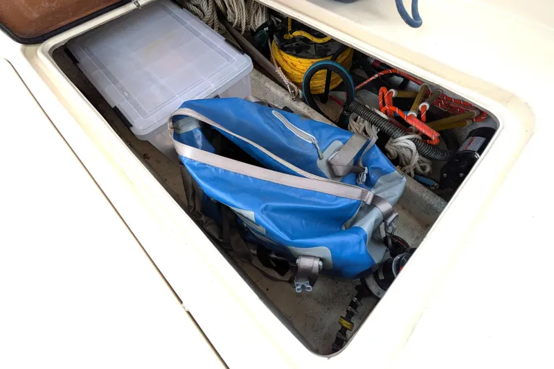 Slide: The Image of Storage compartment of 2003 Atlas Acadia 32 boat with gear and equipment. - 13