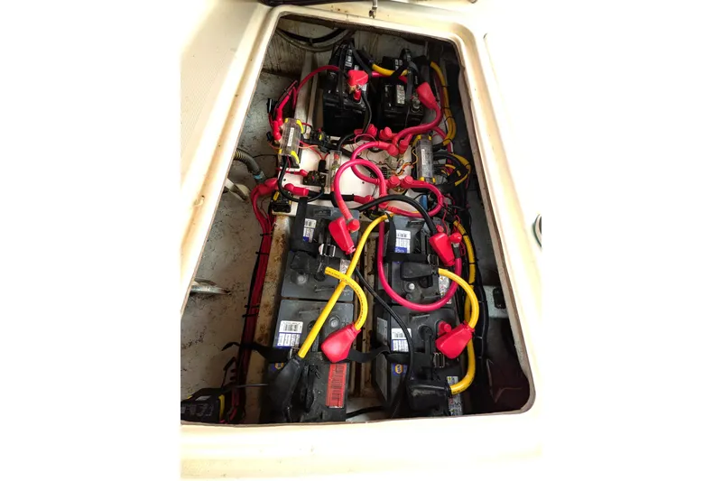 Slide: The Image of Battery compartment of a 2003 Atlas Acadia 32 boat with wiring and connections. - 14