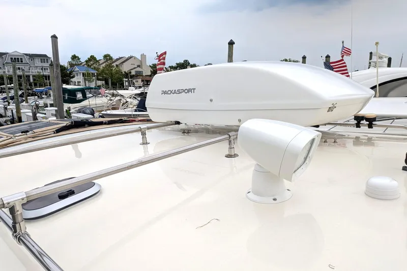 Slide: The Image of Atlas Acadia 32 boat roof with Packasport cargo box, docked at marina, 2003 model. - 44
