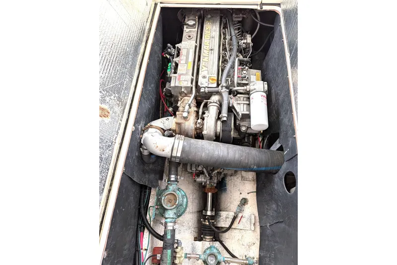 Slide: The Image of Engine compartment of a 2003 Atlas Acadia 32 boat, featuring a Yanmar diesel engine. - 46