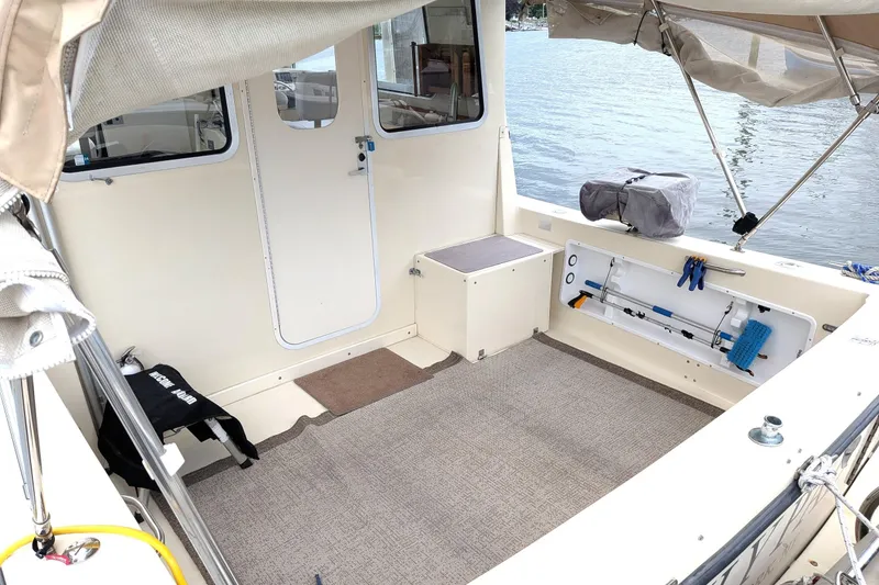 Slide: The Image of 2003 Atlas Acadia 32 boat interior with open deck, storage, and lake view. - 5