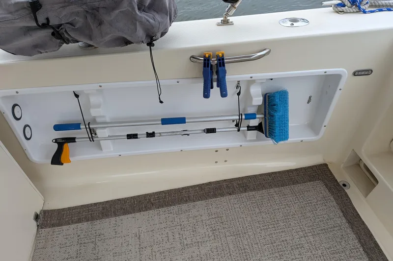 Slide: The Image of Storage compartment on a 2003 Atlas Acadia 32 boat with cleaning tools and accessories. - 7