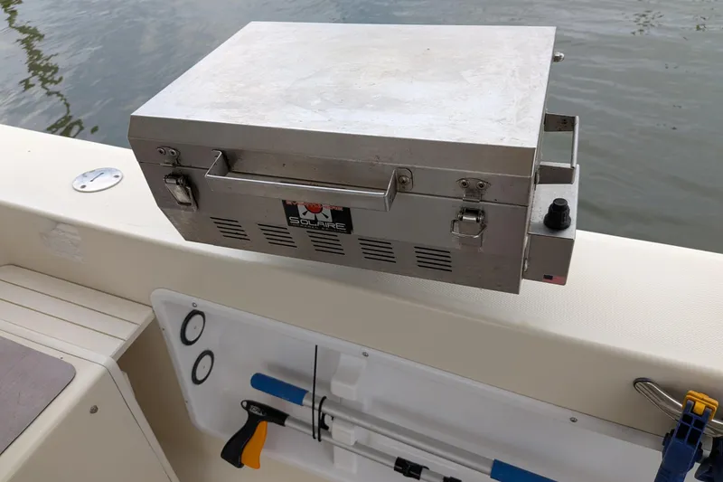 Slide: The Image of Stainless steel grill on Atlas Acadia 32 boat, docked by the water. - 9