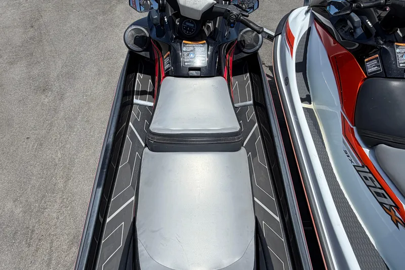 Slide: The Image of 2024 Kawasaki Jetski STX 160LX, top view, parked on concrete surface. - 10