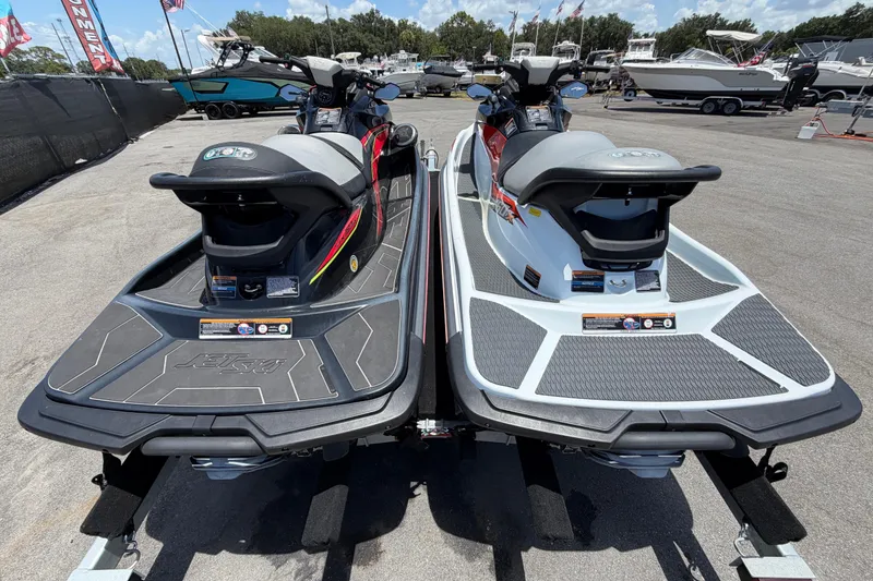 Slide: The Image of 2024 Kawasaki Jetski STX 160LX models displayed on a trailer at a marina. - 3