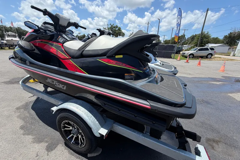 Slide: The Image of 2024 Kawasaki Jetski STX 160LX on trailer, parked outdoors under a sunny sky. - 4