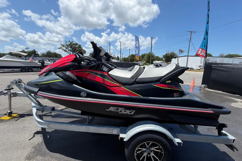 Slide: The Image of 2024 Kawasaki Jetski STX 160LX on trailer under blue sky. - 5