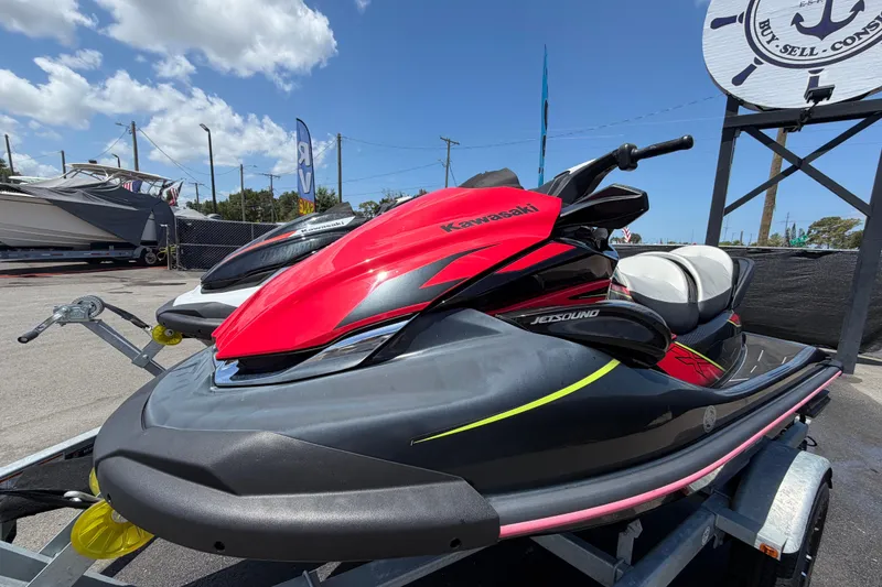 Slide: The Image of 2024 Kawasaki Jetski STX 160LX in vibrant red on a trailer, outdoor display. - 6