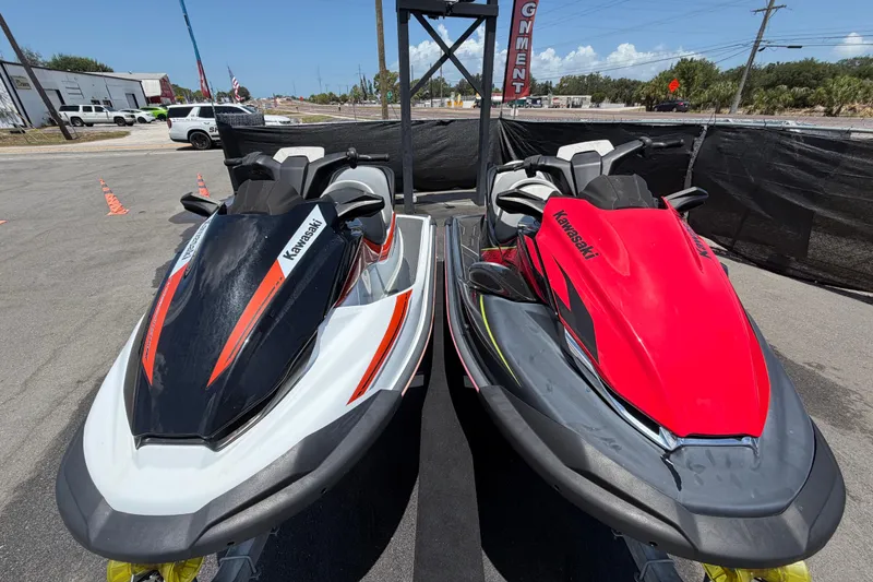 Slide: The Image of 2024 Kawasaki Jetski STX 160LX models in black and red on display outdoors. - 7
