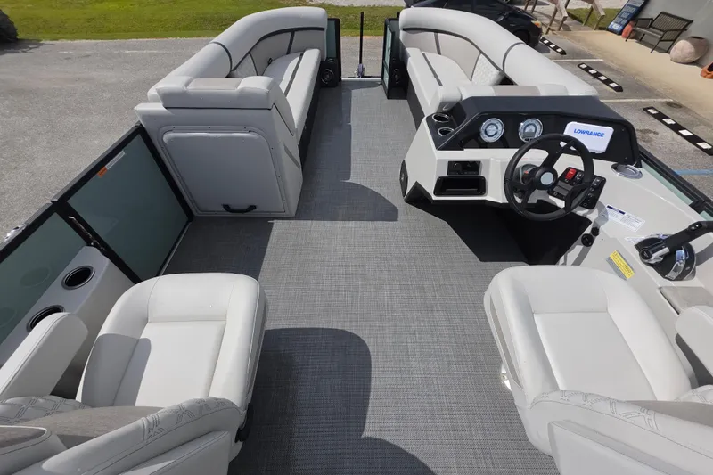 Slide: The Image of 2026 Crest Conquest 235 SLC pontoon boat interior with plush seating and modern dashboard. - 16
