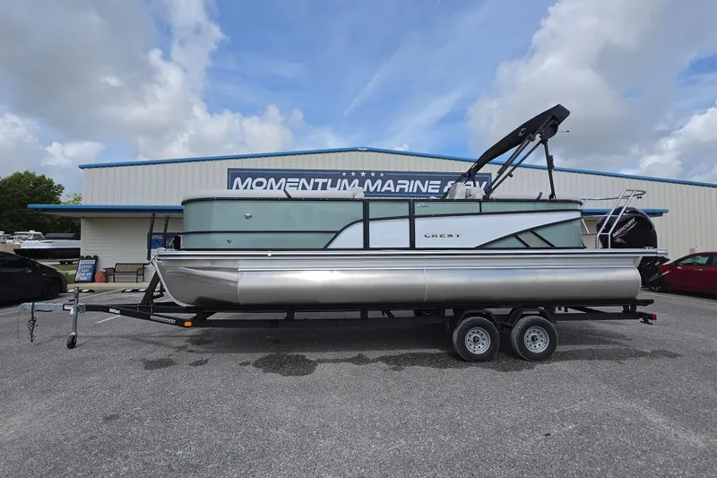 The Image of 2026 Crest Conquest 235 SLC pontoon boat on trailer at dealership. - 1