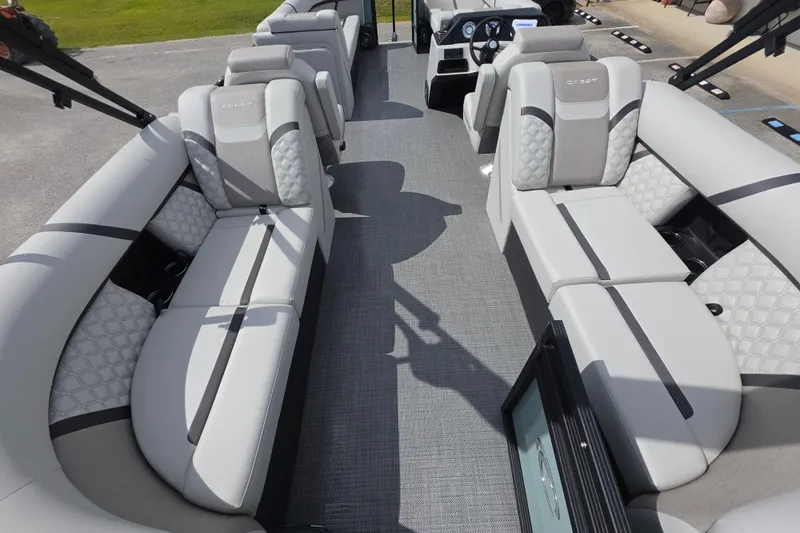 Slide: The Image of 2026 Crest Conquest 235 SLC pontoon boat interior with luxurious seating and modern design. - 15