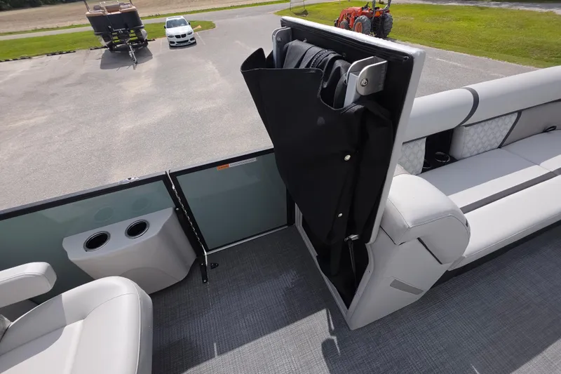 Slide: The Image of 2026 Crest Conquest 235 SLC boat interior with seating and storage compartment. - 19