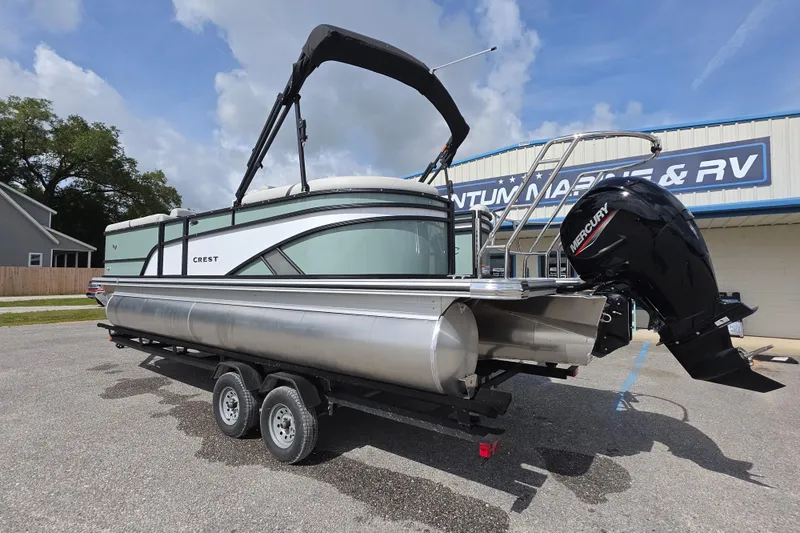 Slide: The Image of 2026 Crest Conquest 235 SLC pontoon boat with Mercury engine on trailer. - 5