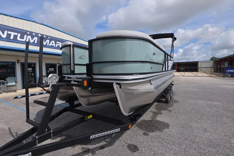 Slide: The Image of 2026 Crest Conquest 235 SLC pontoon boat on trailer at dealership. - 2