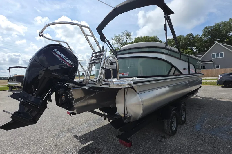 Slide: The Image of 2026 Crest Conquest 235 SLC pontoon boat with Mercury outboard motor on trailer. - 7