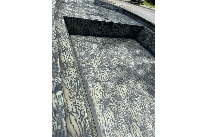 Slide: The Image of 2025 Tracker Grizzly 1860 AWL boat interior with camouflage pattern flooring. - 9
