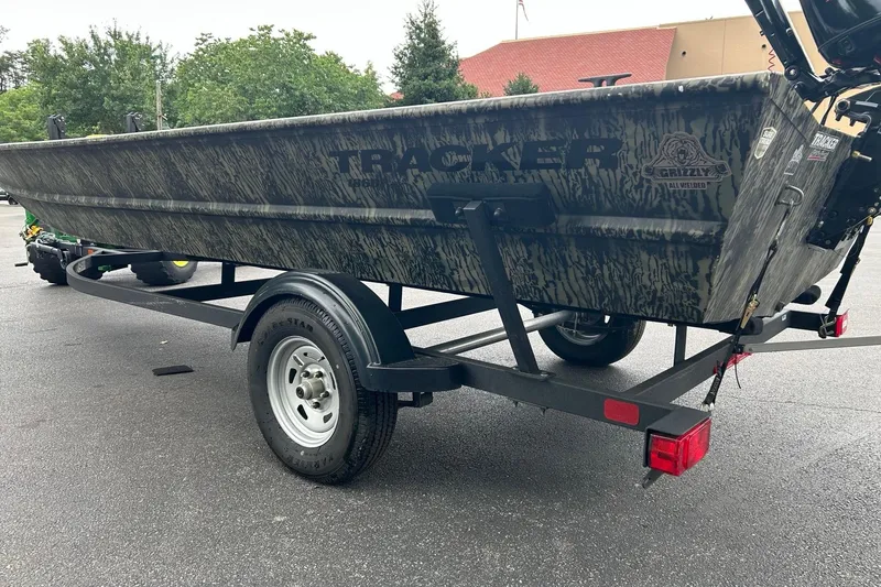 Slide: The Image of 2025 Tracker Grizzly 1860 AWL boat on trailer, parked outdoors. - 3