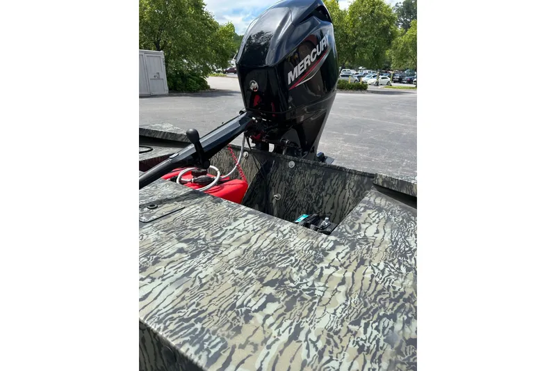 Slide: The Image of 2025 Tracker Grizzly 1860 AWL boat with Mercury outboard motor, camo design. - 8