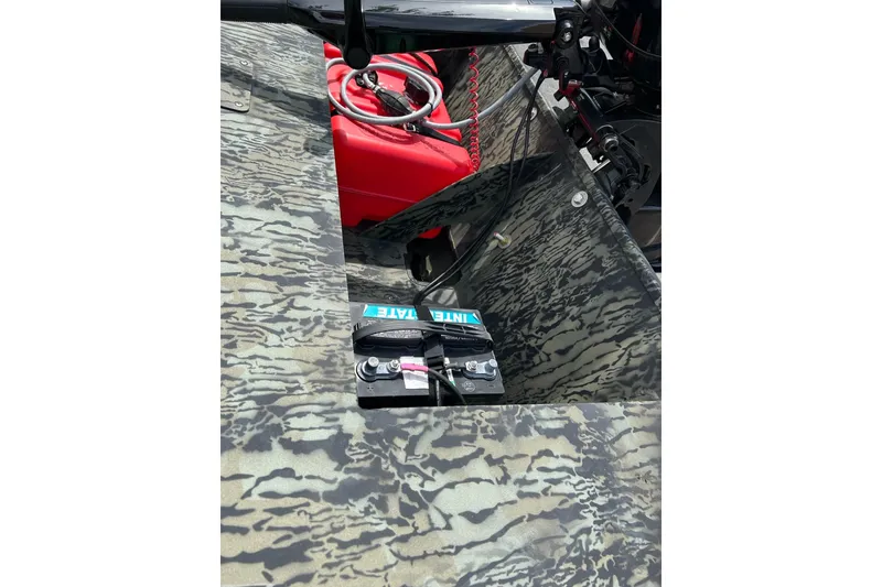 Slide: The Image of 2025 Tracker Grizzly 1860 AWL boat interior with camouflage design and battery setup. - 7