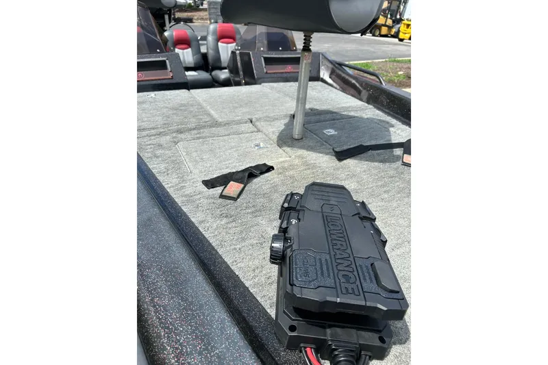 Slide: The Image of 1988 Aries Bass boat interior with Lowrance equipment on carpeted deck. - 8