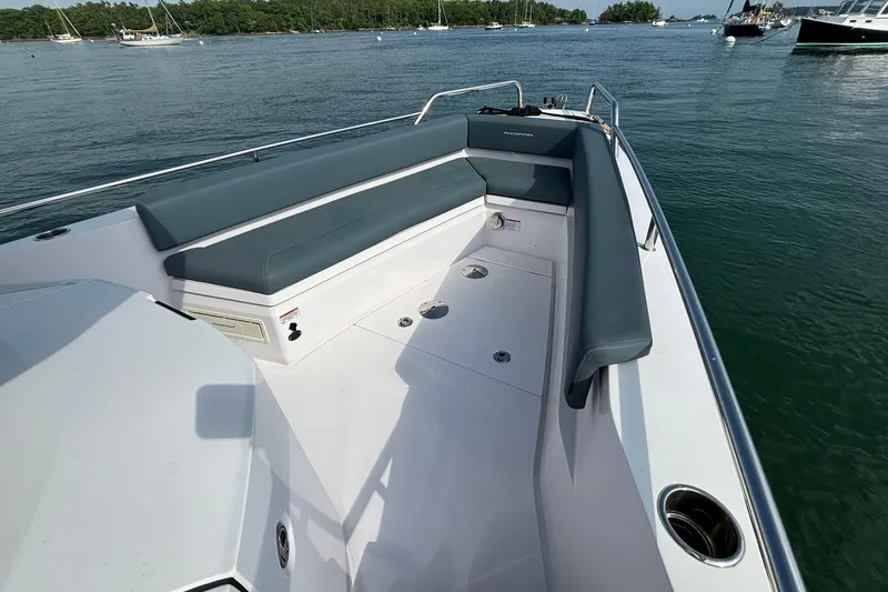 Slide: The Image of 2022 Axopar 28 Cabin boat with spacious seating, docked on calm waters. - 10