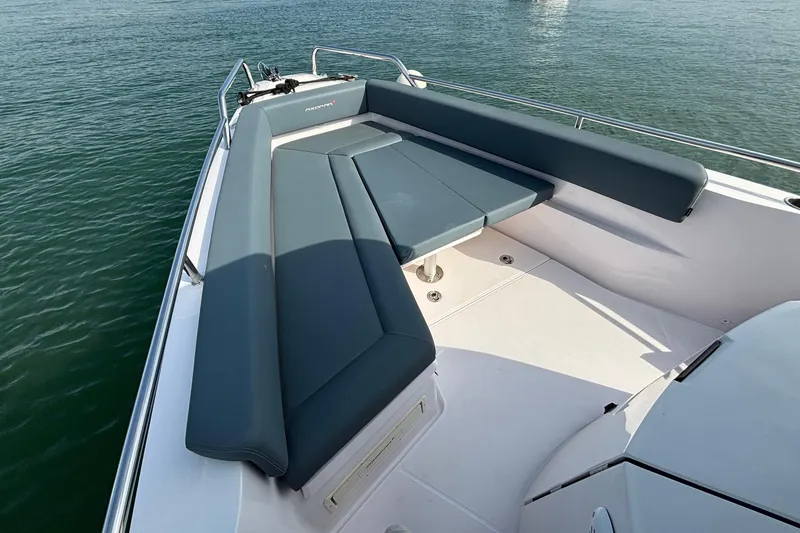 Slide: The Image of 2022 Axopar 28 Cabin boat with spacious seating area on calm water. - 15