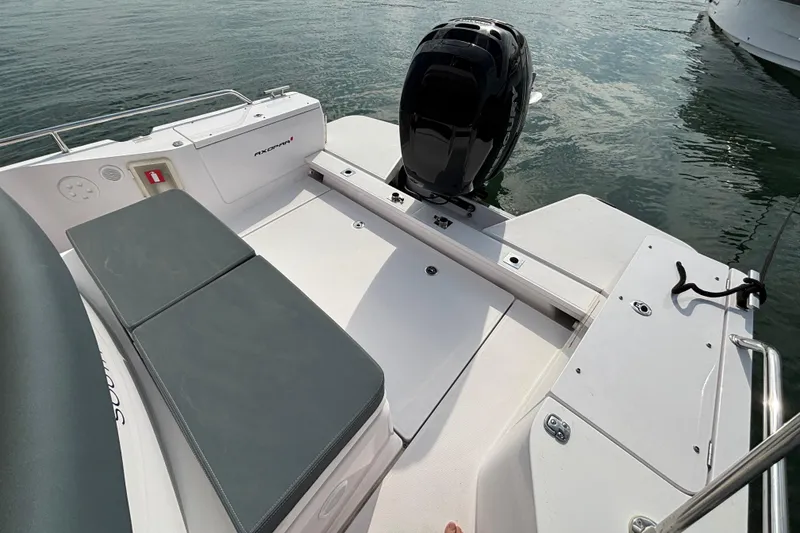 Slide: The Image of 2022 Axopar 28 Cabin boat deck with seating and outboard motor. - 16