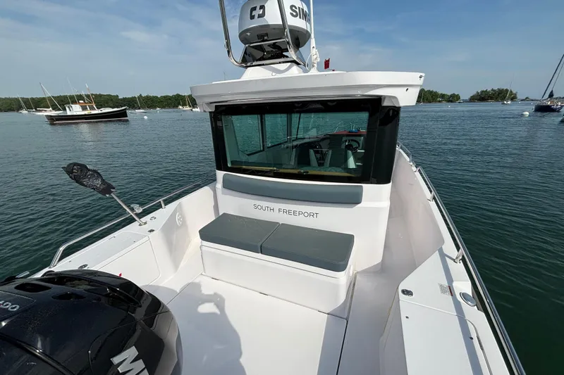 Slide: The Image of 2022 Axopar 28 Cabin boat on calm water, featuring sleek design and modern amenities. - 17