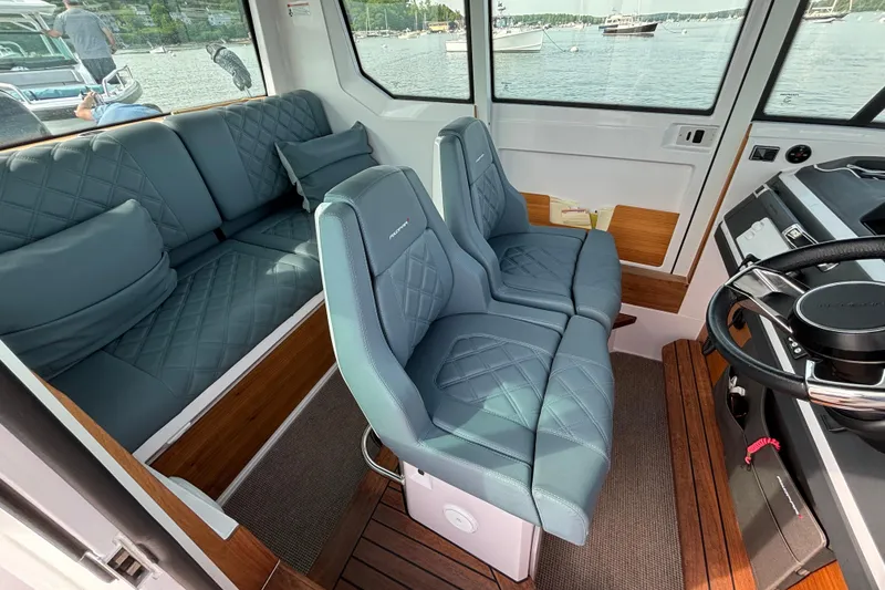 Slide: The Image of Interior of 2022 Axopar 28 Cabin boat with plush seating and modern design. - 19