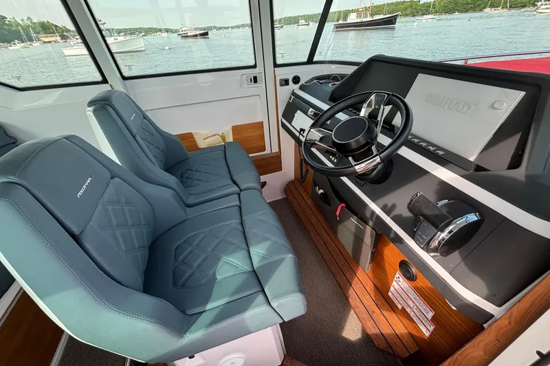 Slide: The Image of Interior of 2022 Axopar 28 Cabin boat with modern steering and dual seats. - 20