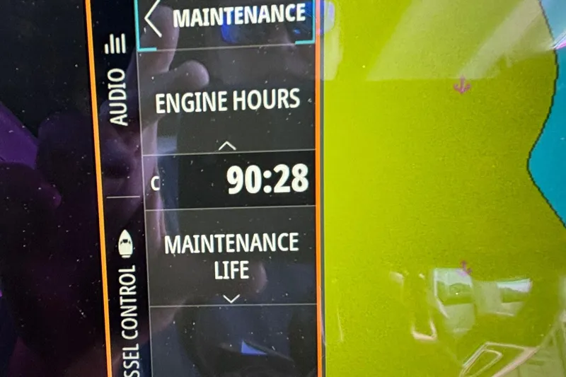 Slide: The Image of Display screen showing maintenance details with 90:28 engine hours on Axopar 28 Cabin, 2022. - 24