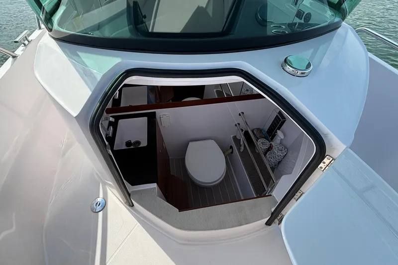 Slide: The Image of 2022 Axopar 28 Cabin boat interior with compact bathroom view. - 26